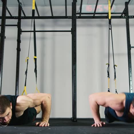 two athletes do strength exercises in the gym