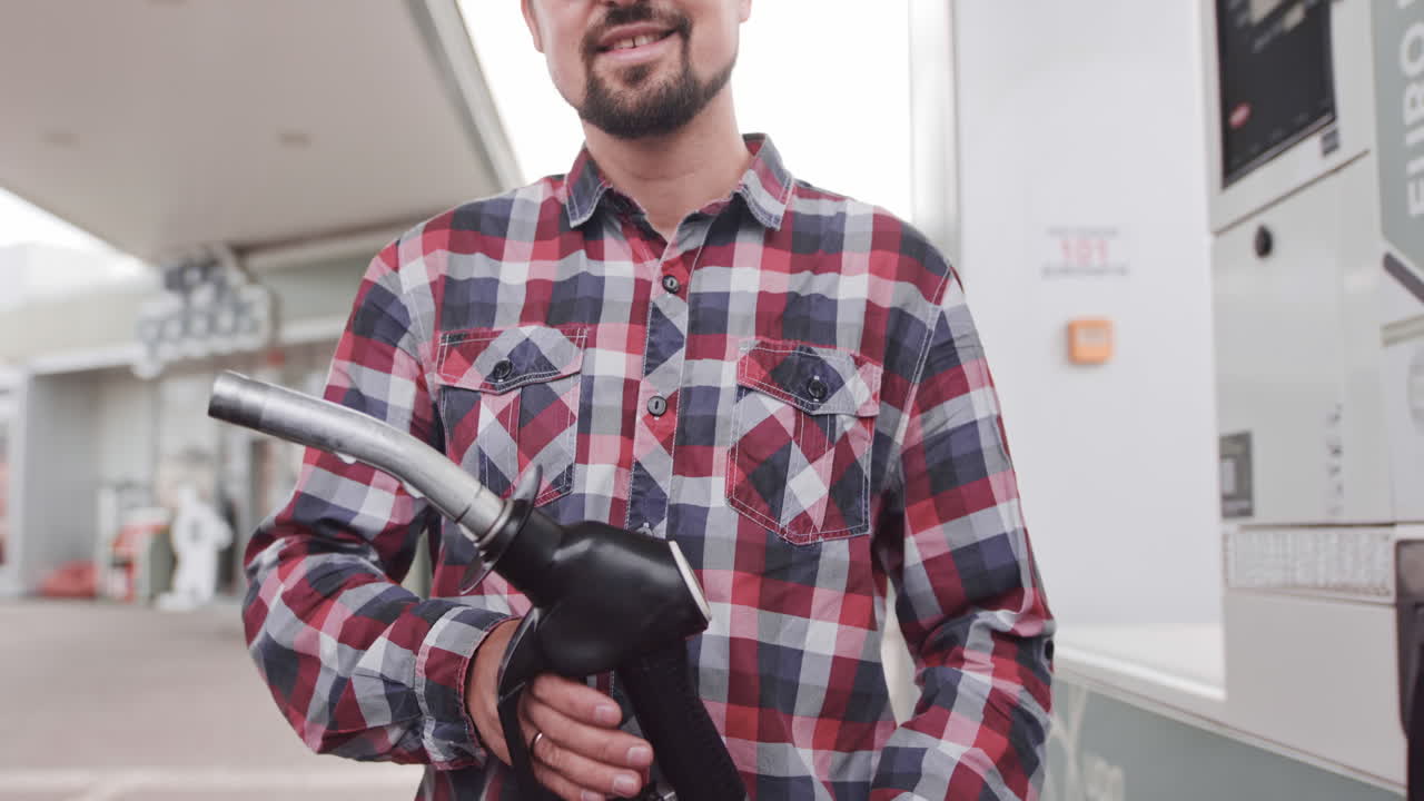 Man Filling Up Car at Gas Station
