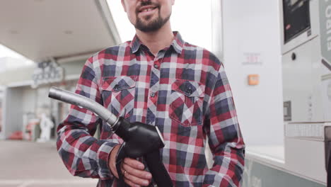 man filling up car at gas station
