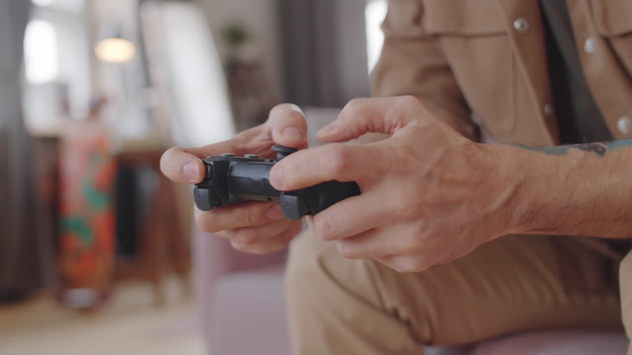 Hands of Man Using Controller and Playing Console Game