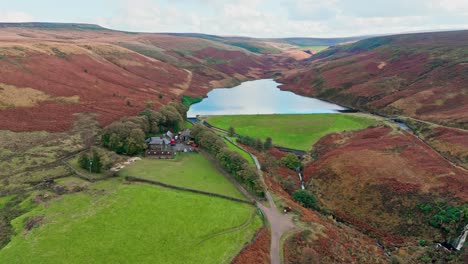 aerial drone video of the beautiful english countryside, wild landscape showing moorlands covered in heather, large lakes and blue water