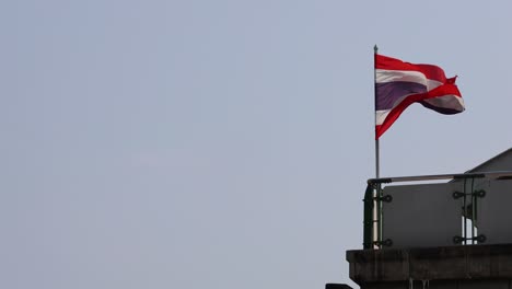 national flag waving in the wind on building