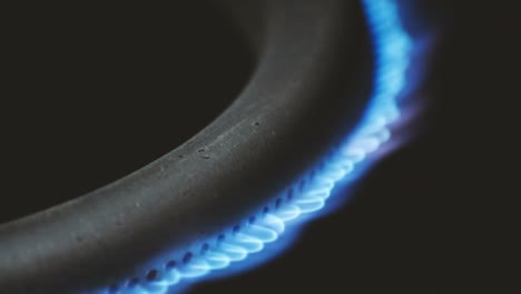 burning gas burner in the oven close-up on a black background. 4k macro raw video.