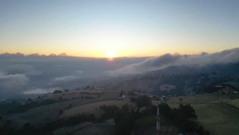 drone shot pulling away from sunset over mountains in cartago costa rica