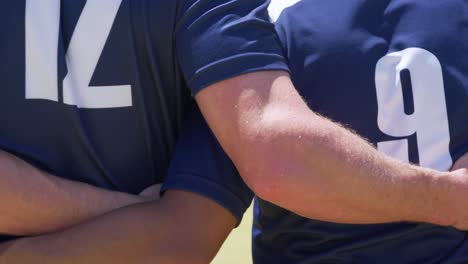 rugby players holding each other on field