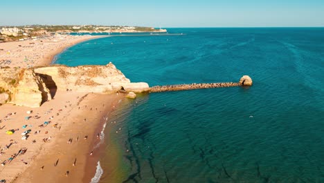 algarve beach view with sunbathers and fun water activities