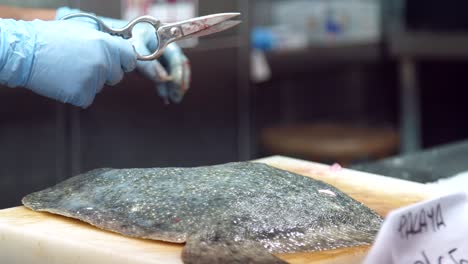 fishmonger preparing fish