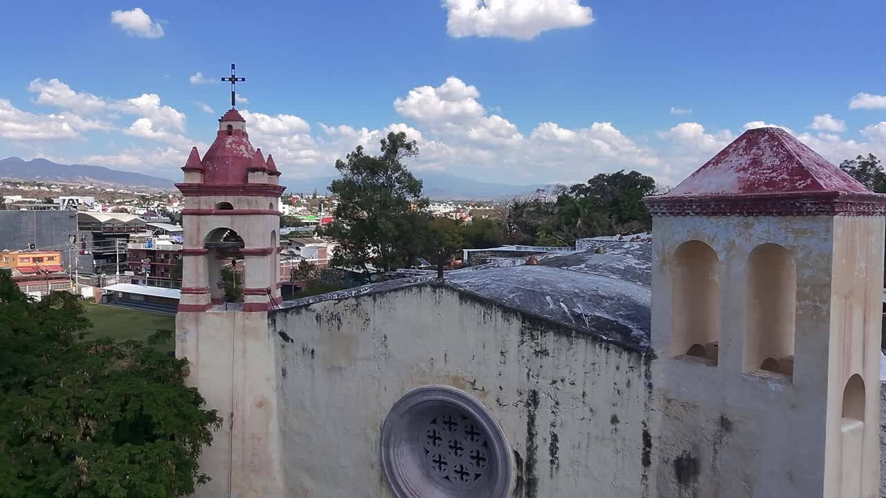 aerial view of the roof of the facade of a large old church with the blue sky above it
