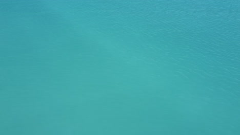 Rosignano-Solvay,-aerial-view-of-Spiagge-Bianche,-focus-on-crystal-water