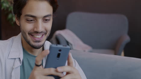 young man using smartphone in cafe