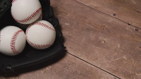 overhead studio baseball still life with balls in catchers mitt on wooden floor 2