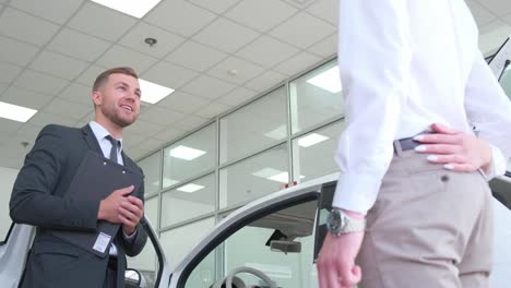 car salesman assisting customer