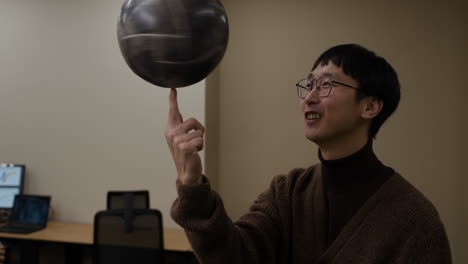 man juggling a basketball on his finger