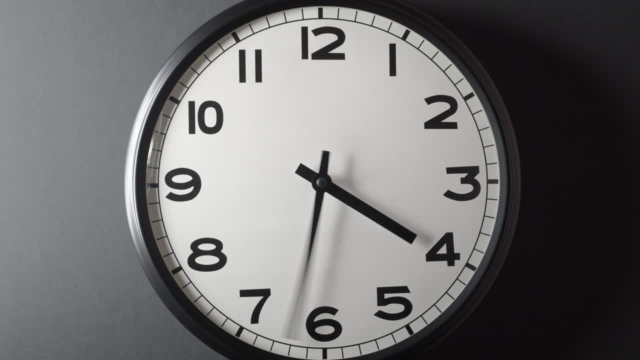 Clock Face Full Circle 12 hours on dark grey background in time lapse