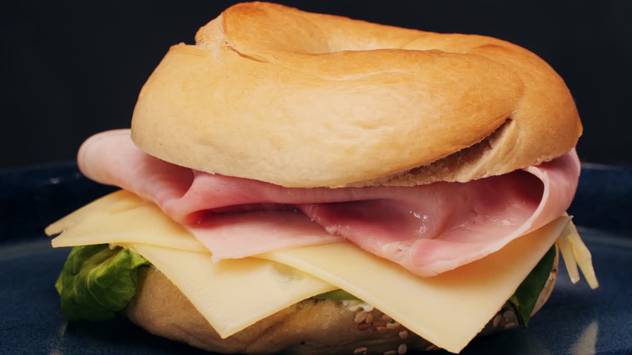 Bagel sandwich brunch, lunch plate of a bagel with smoked salmon and cream cheese and ham, close up morning cafe menu.