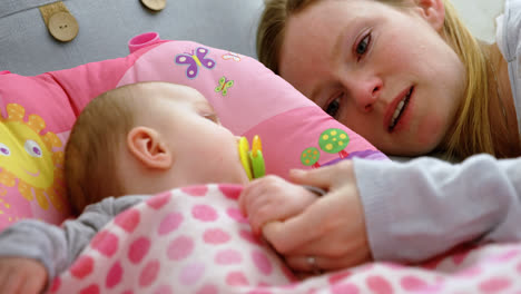 mother putting his baby to sleep on baby bed 4k