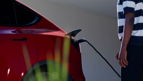 person charging an electric vehicle