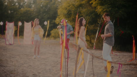 Young-couples-dancing-while-grooving-near-ribbons