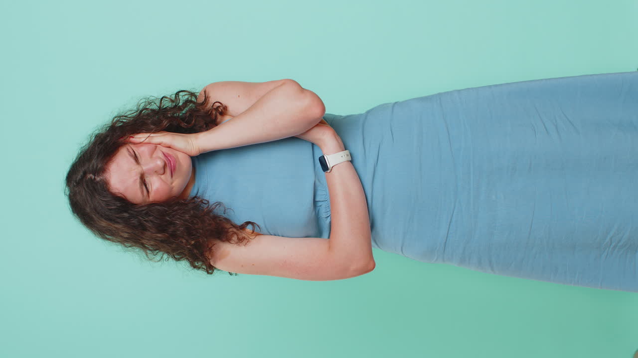 Young woman touching cheek closing eyes with expression of terrible suffer from painful toothache