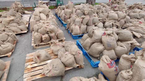 circular view of many sandbags piled up on pallets before being used