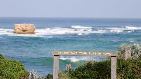 sign urging rubbish removal by the ocean