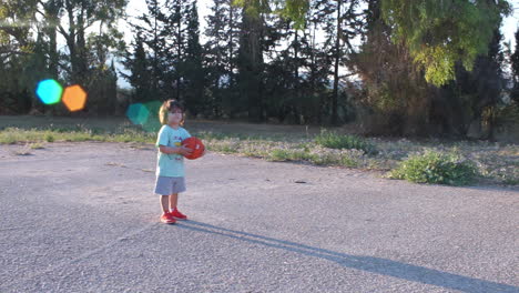 A-kid-playing-with-a-basket-ball-outdoors-in-a-sunny-day-,-Athens,-Greece