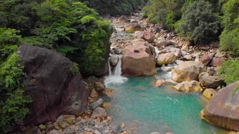 4k-Aerial-Fly-Forward-shot-of-a-Water-Pool-near-Rainbow-falls-in-Nongrigat,-Cheerapunji,-Meghalaya