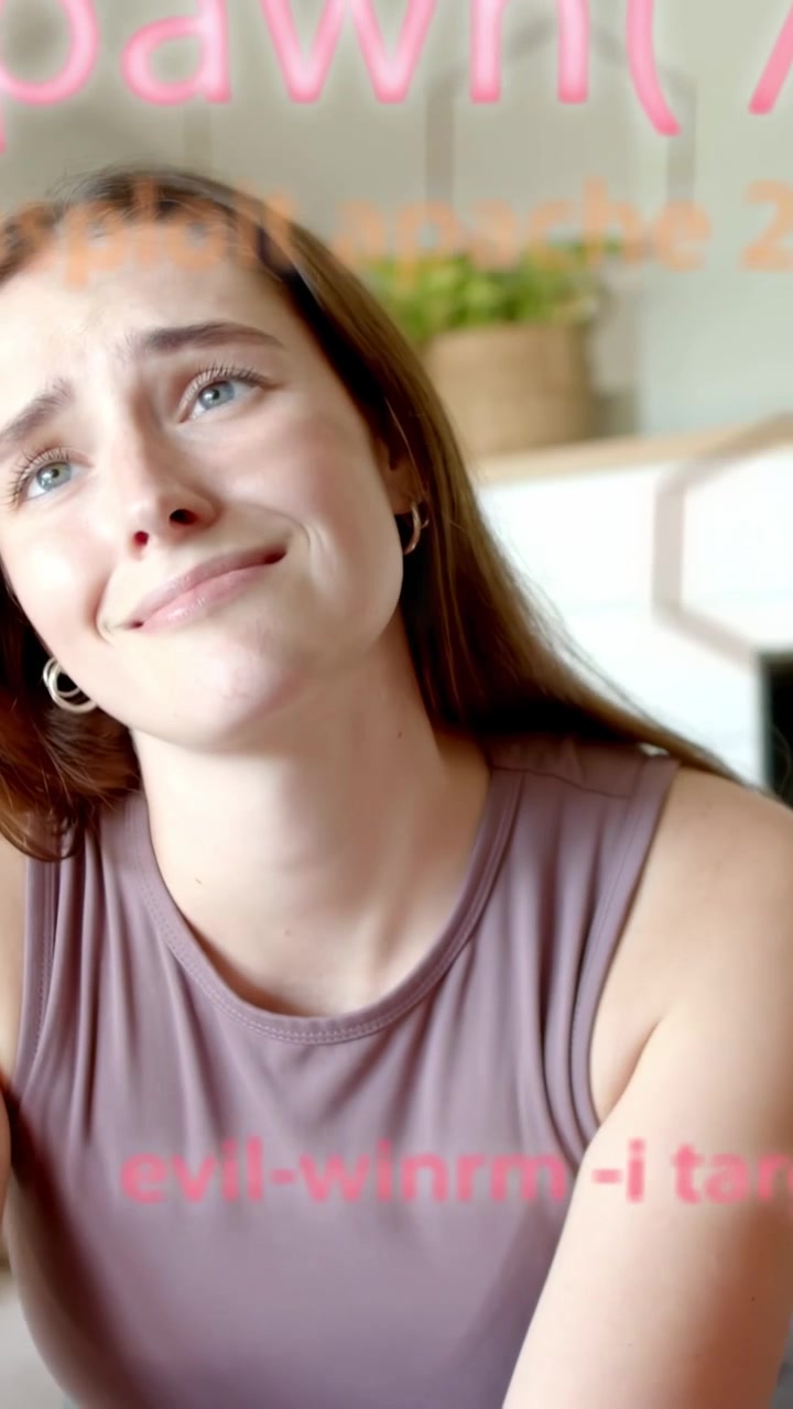Vertical video: Seated woman replying to off-frame cue, explaining tech while pink code over face