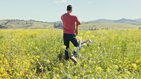 playing, man and child in field of flowers bonding