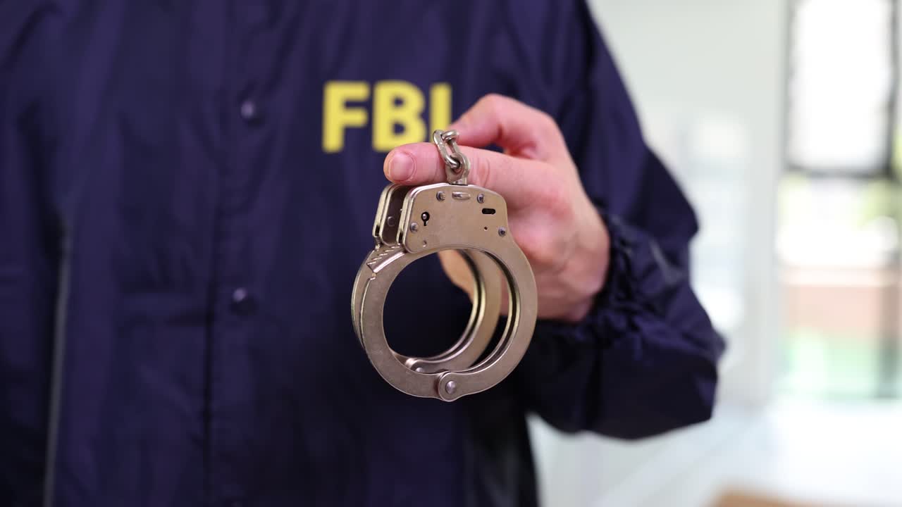 FBI Agent Holding Handcuffs