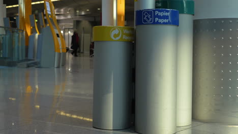 Woman-throwing-garbage-into-paper-litterbin