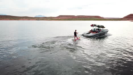 drone shot of wake surfing in lake powell utah