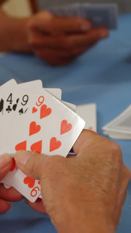 senior friends playing cards