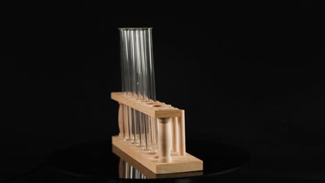 empty test tubes displayed in a wooden rack