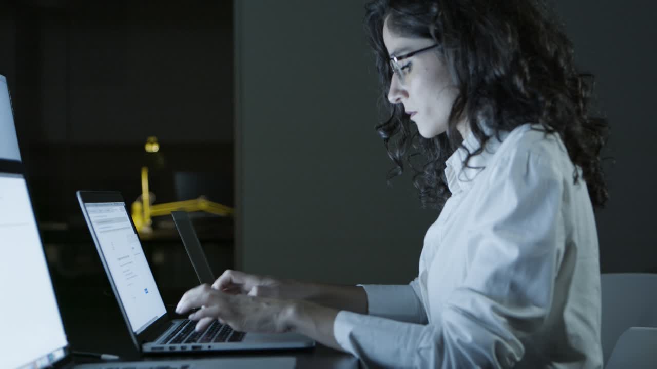 Concentrated young businesswoman using laptop