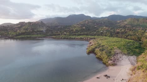 Aerial-of-mangrove-during-sunny-day,-with-no-people-and-mountains-in-the-background