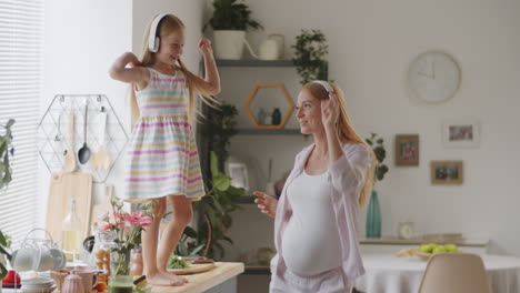 mother and daughter dancing in kitchen