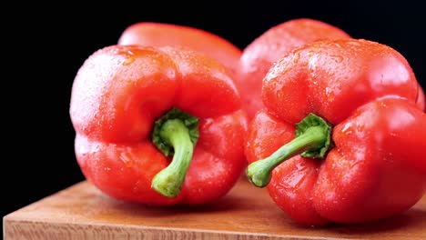 fresh red peppers on wooden chopping board, healthy vegetables