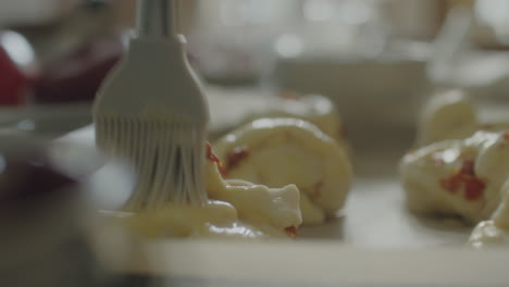 brushing unbaked savory pastries with egg wash