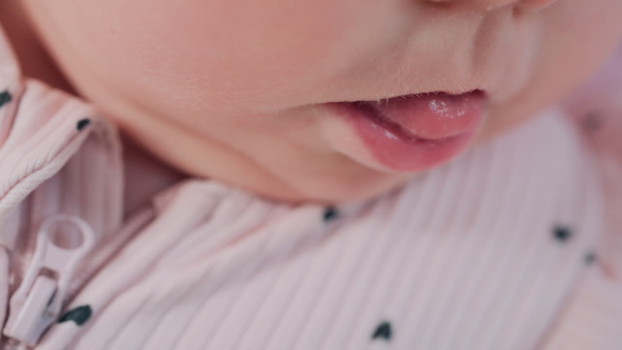 Close up of baby's lips and cheeks in warm pastel light