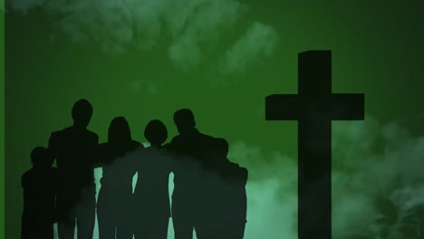 Animation-of-silhouettes-of-Christian-cross-and-family-on-green-backgroud