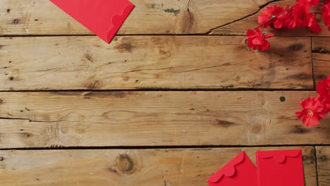 video of envelopes and red flowers on wooden background