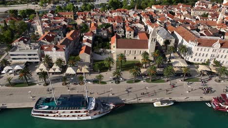aerial fly waterfront, coastline of trogir croatia, summer town travel destination, historic buildings and cruises