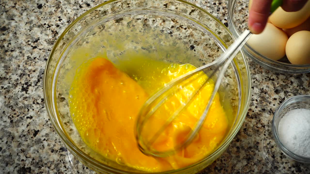 Beating of eggs in a bowl. Slow motion