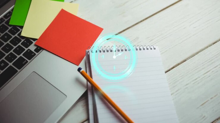 Animation of clock over laptop over desk