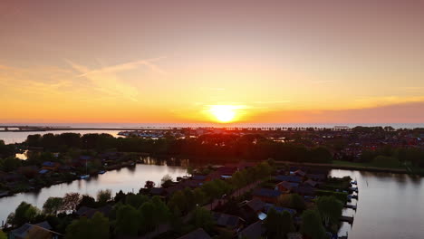 stunning sunset over the vast waterscape. silhouette of a village located on the water at foreground.