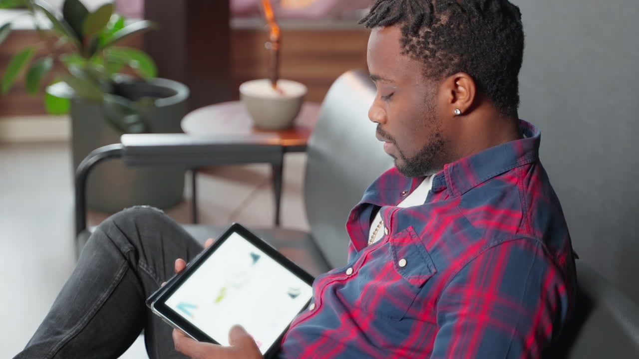 Man using a tablet on a couch