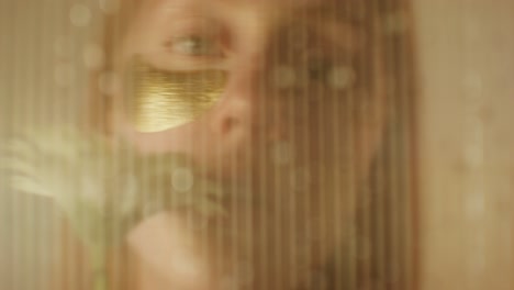 woman with gold mask, blurred view through a window