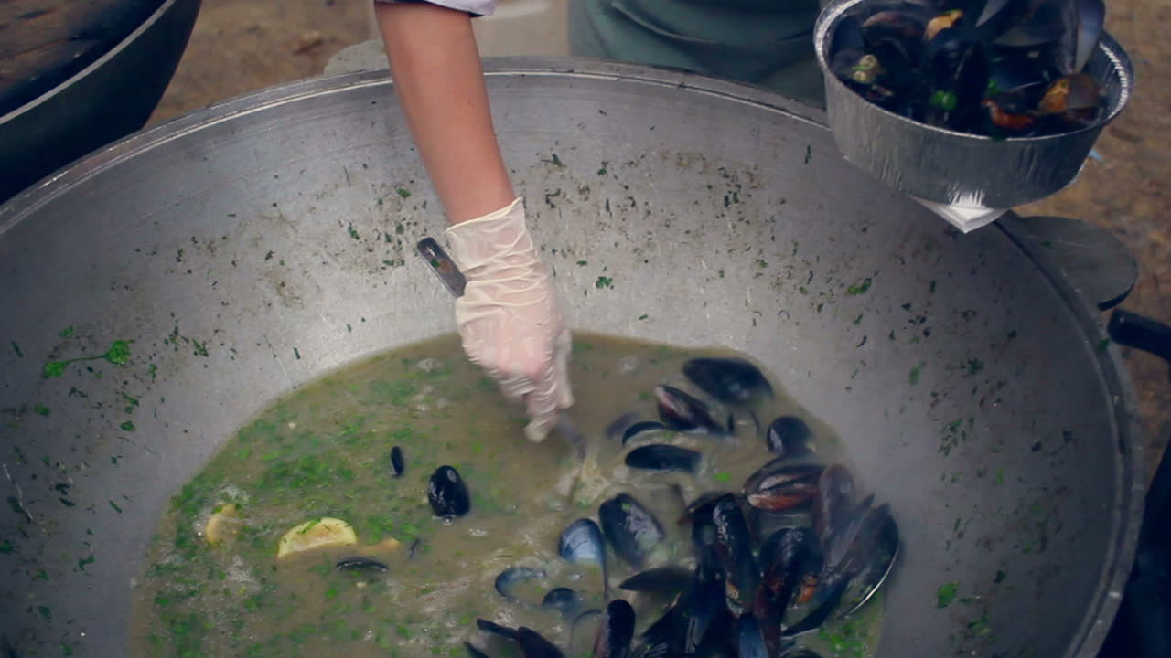 Seafood soup with mussels. Mussel soup in bowl. Cooking seafood in pan