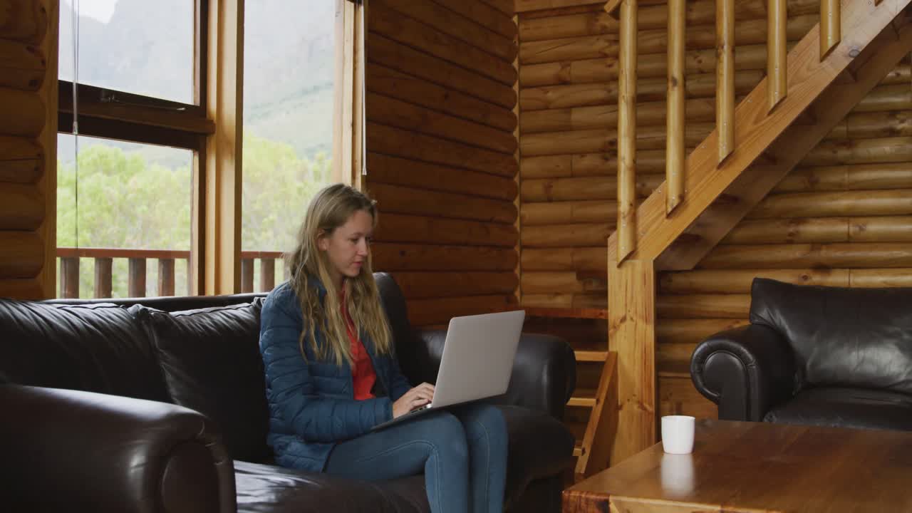 Caucasian woman spending time at home, working on a laptop